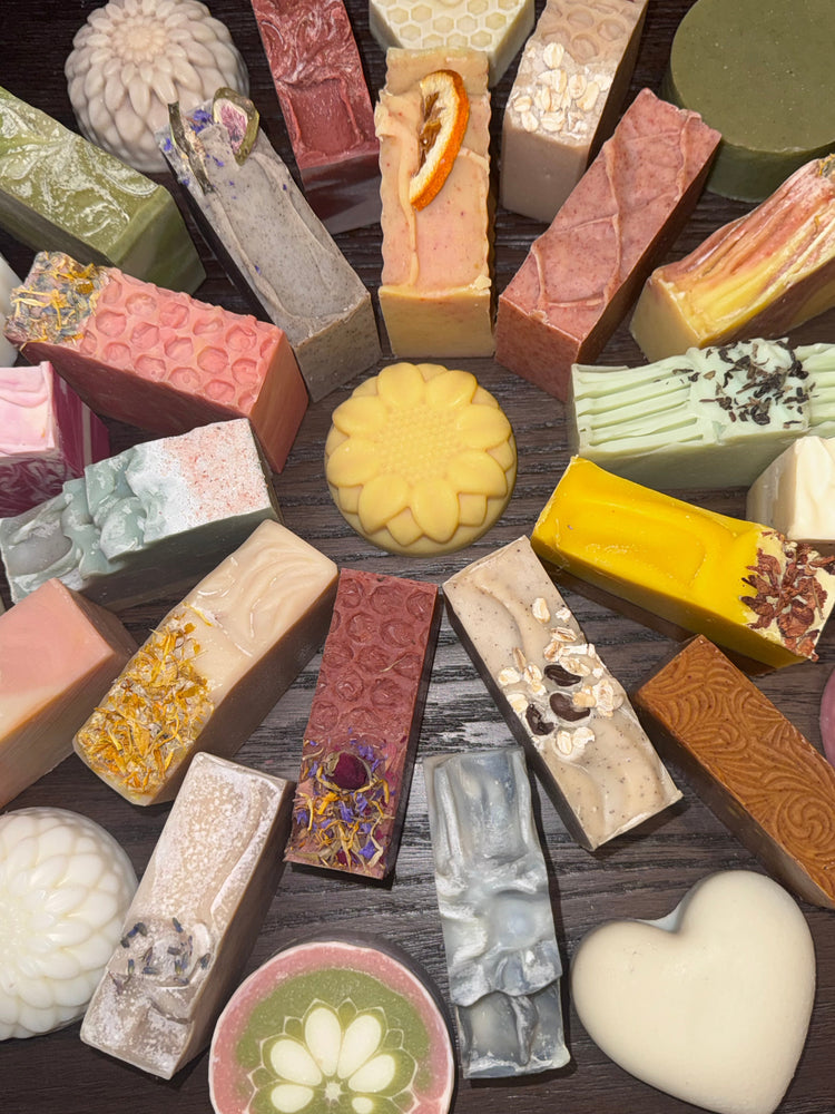 Multiple soaps circling around a yellow sunflower bar of soap