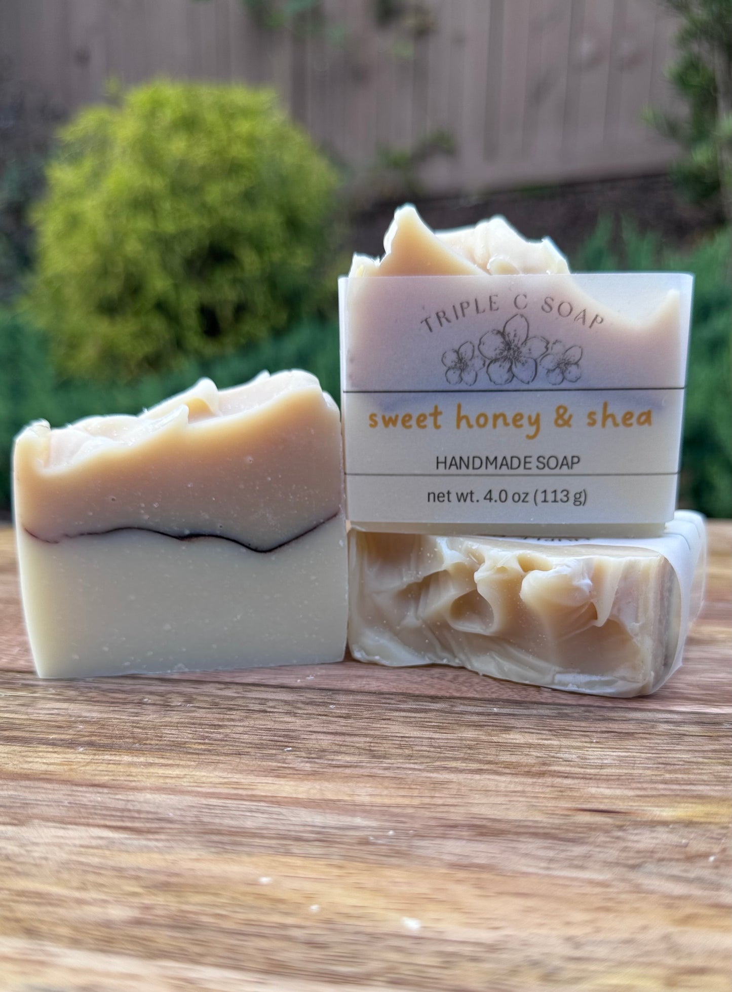 Three bars of soap with white and beige layer and Sweet Honey & Shea label