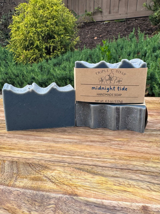 Three bars of handmade soap labeled 'Triple C Soap' on a wooden surface.