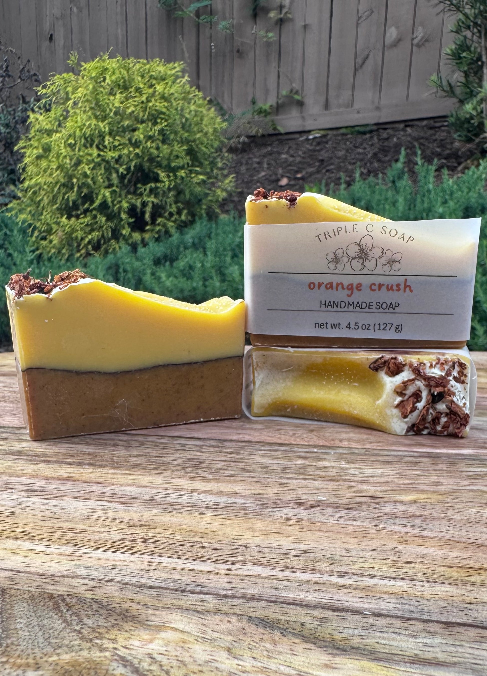 Handmade soap with a visible label on a wooden surface outdoors