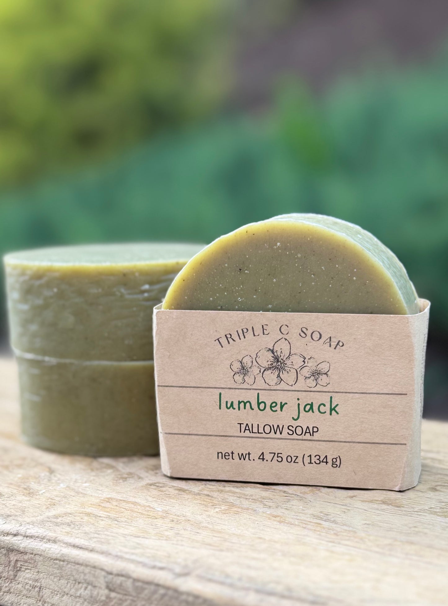 Three bars of soap labeled 'Triple C Soap Lumber Jack Tallow Soap' on a wooden surface.