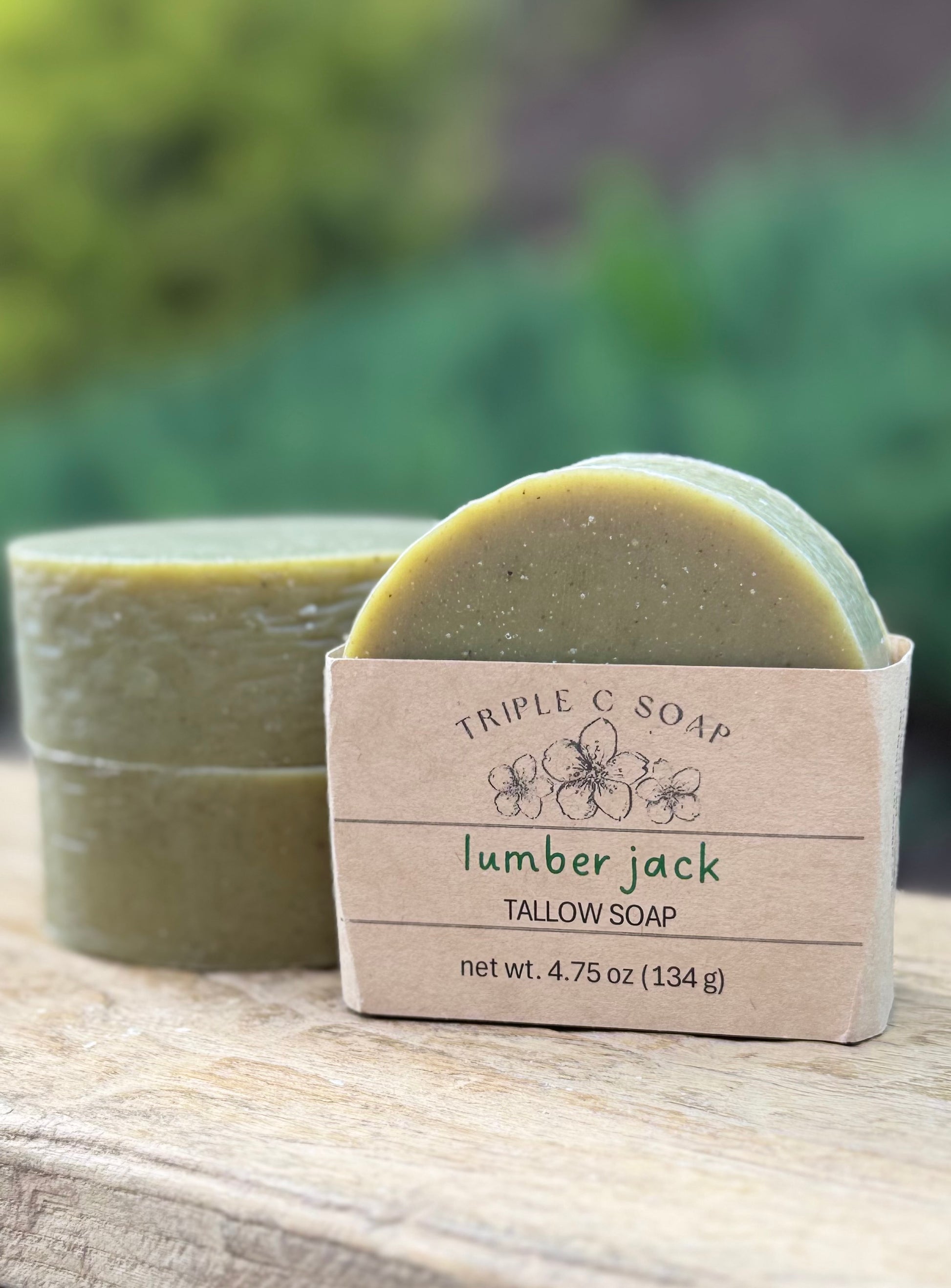 Three bars of soap labeled 'Triple C Soap Lumber Jack Tallow Soap' on a wooden surface.